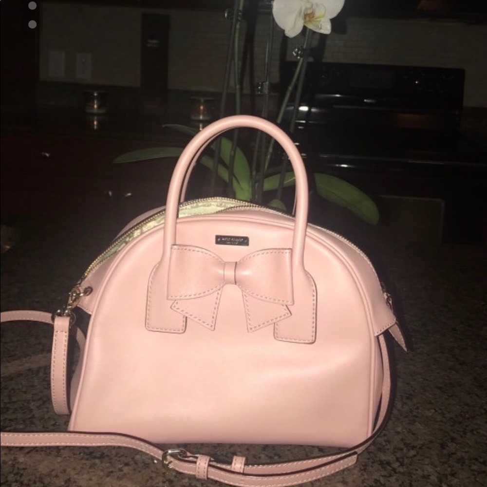 Pink leather kate spade purse with bow accent